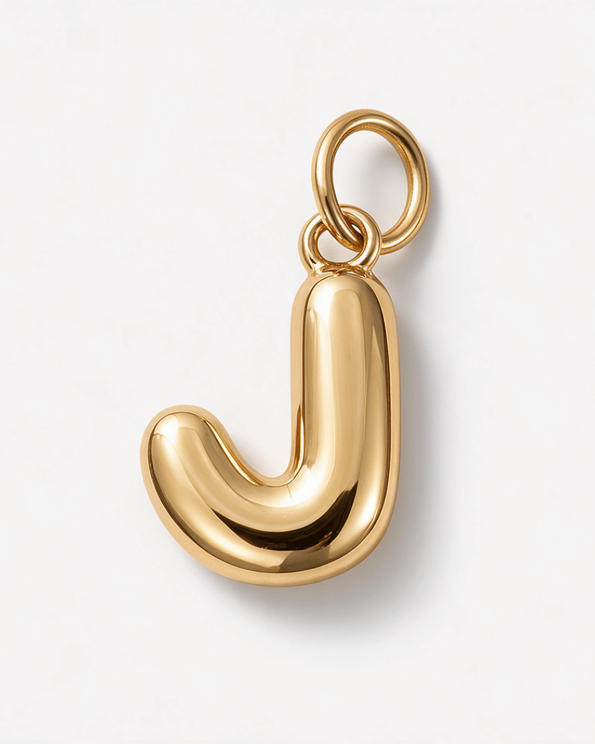 A polished gold initial pendant charm shaped like the letter 'J', featuring a smooth, rounded silhouette and a top loop, shown on a clean white background.