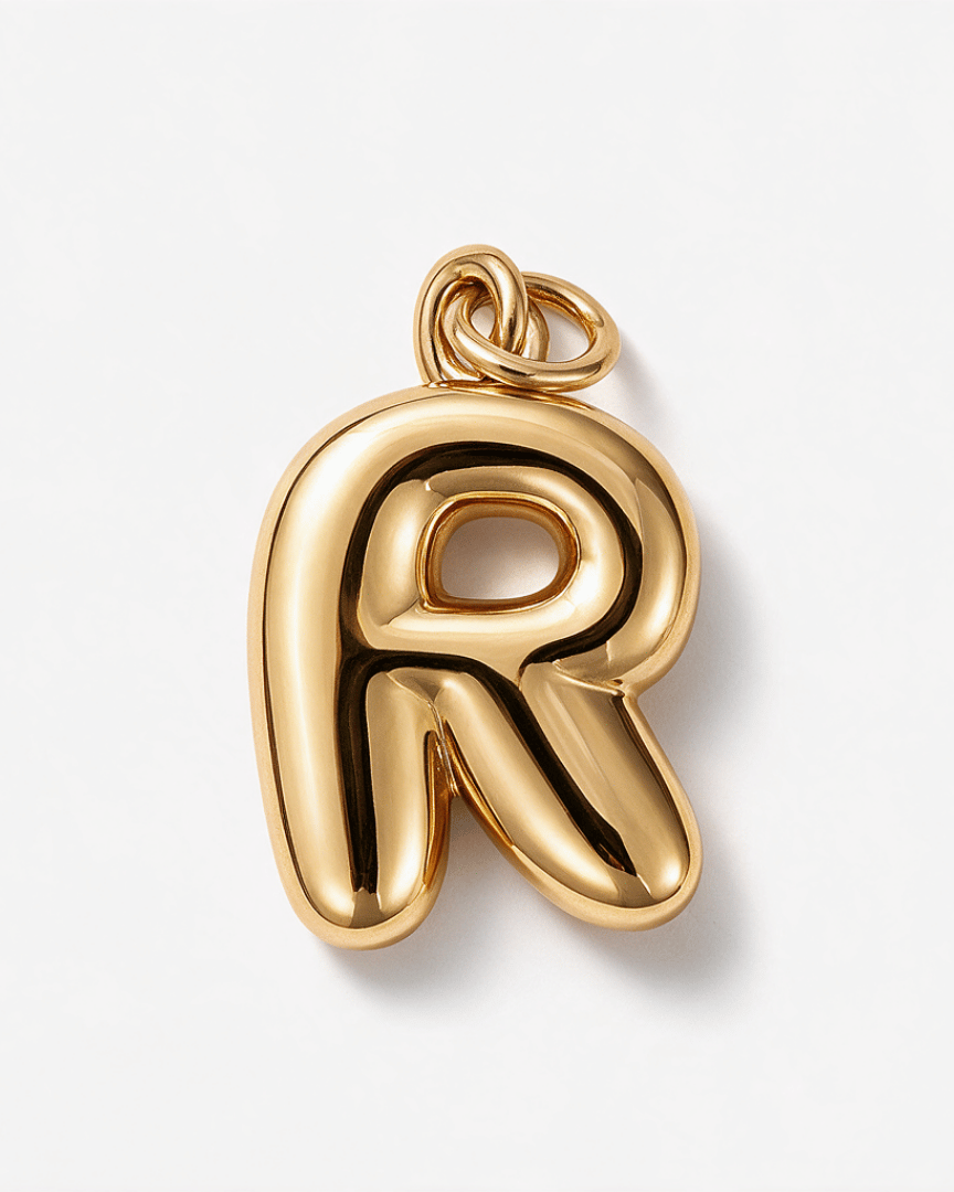 A polished gold letter 'R' pendant charm with a smooth, rounded, balloon-like silhouette and a top loop, shown on a clean white background.