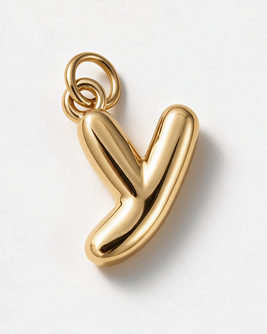 A polished gold pendant shaped like the letter 'Y', featuring a smooth, glossy finish and a hanging loop at the top, photographed on a clean white background.