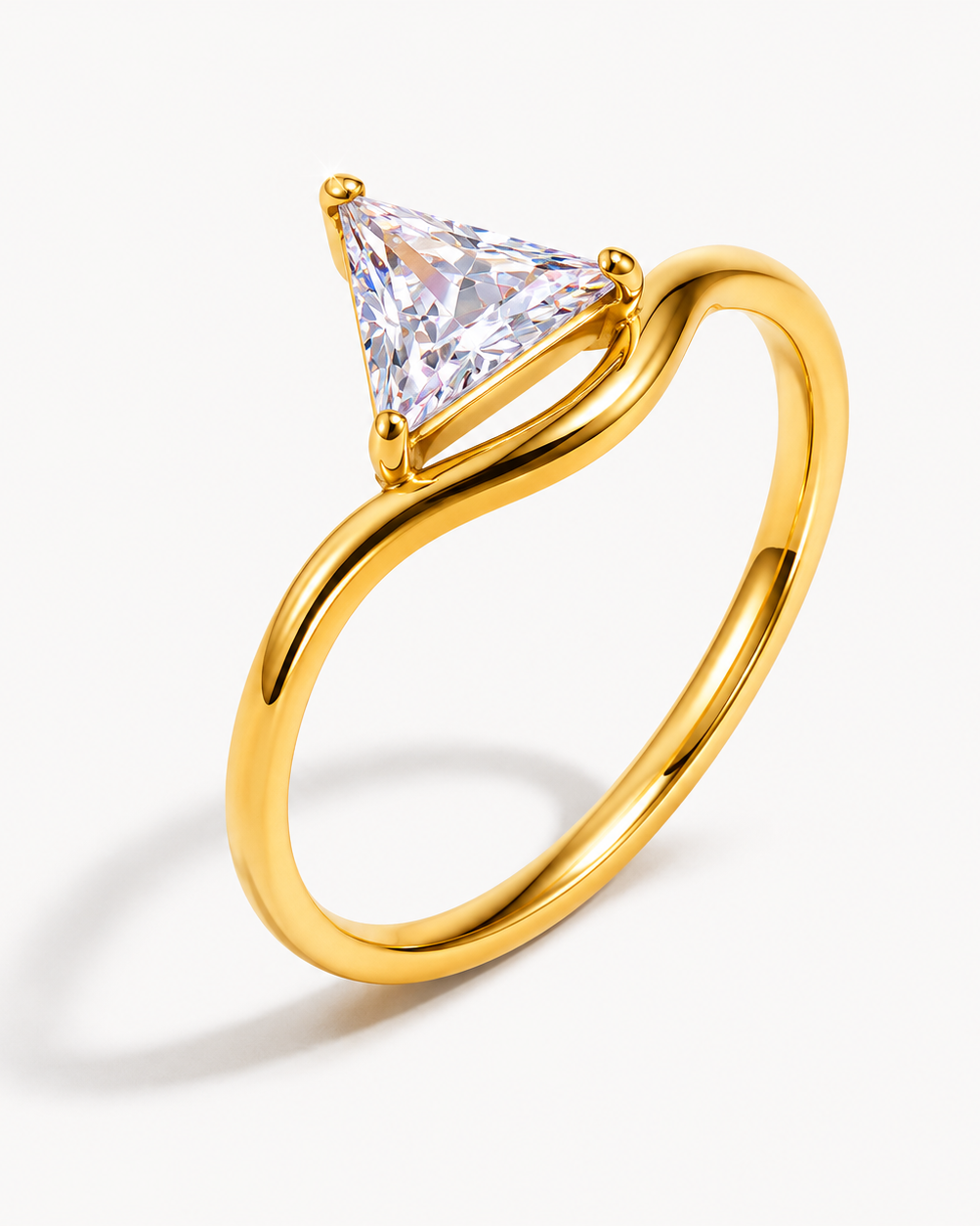 Gold ring with a triangular cut diamond on a white background. collection-image