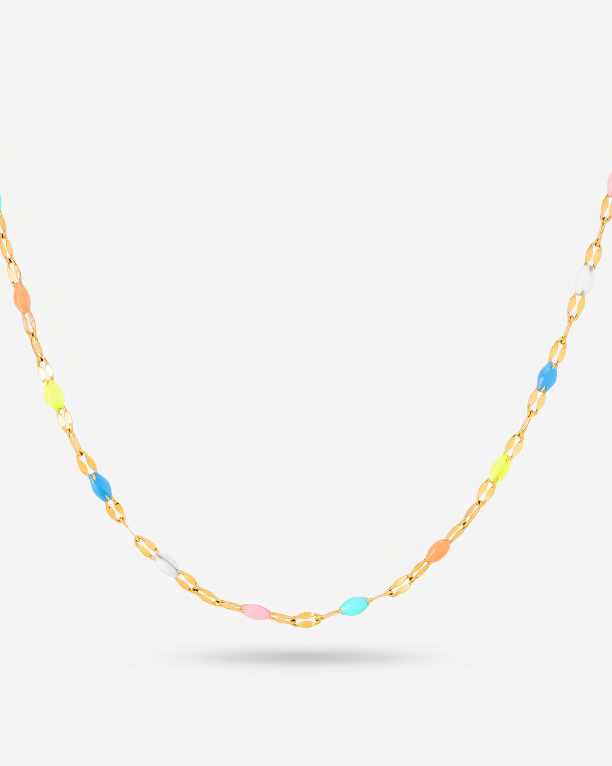 A delicate gold chain necklace featuring small, evenly spaced pastel-colored oval beads in blue, pink, yellow, and white, displayed against a clean light gray background. collection-image