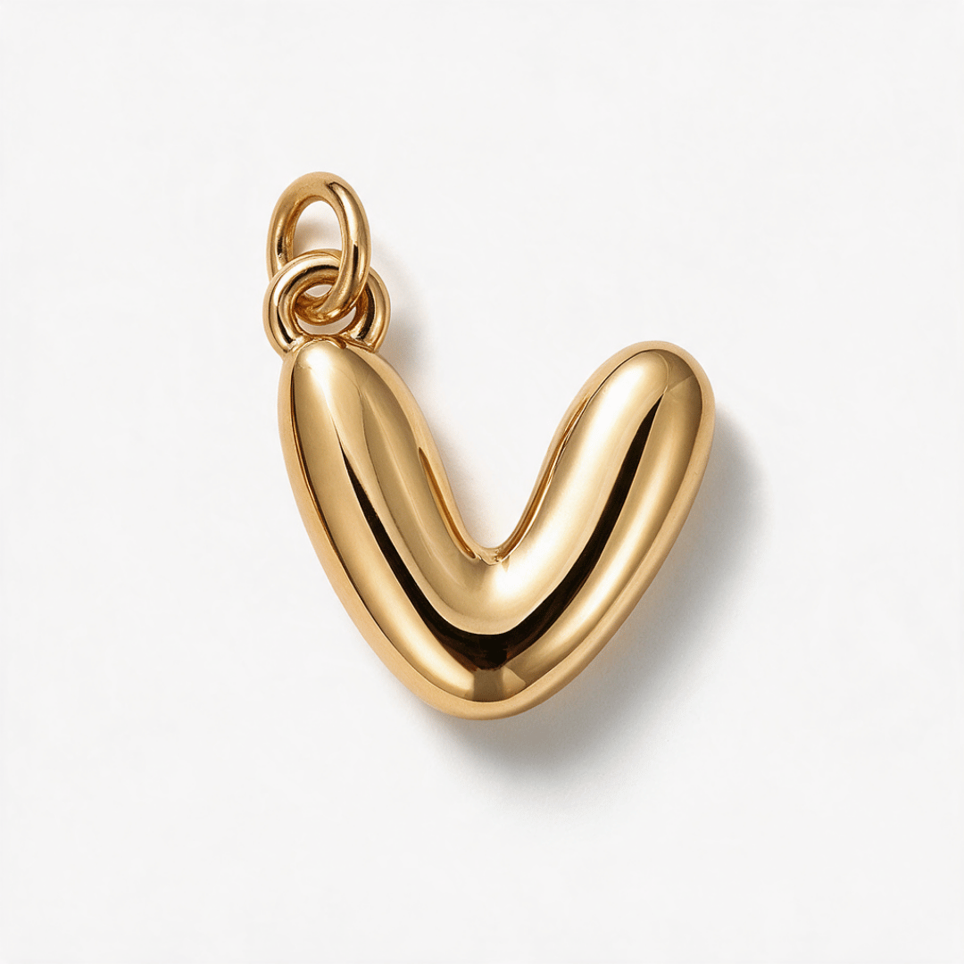 A polished gold pendant shaped like a stylized lowercase 'v' or rounded abstract letter, shown on a clean white background with a soft shadow.
