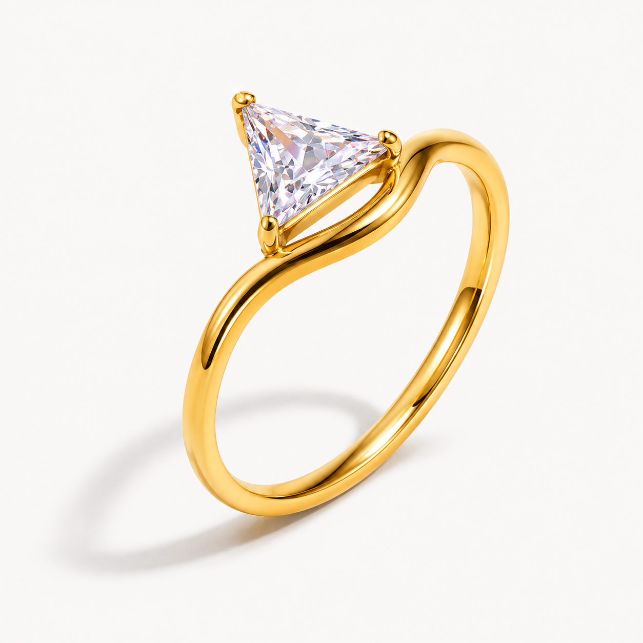 Gold ring with a triangular cut diamond on a white background. collection-image