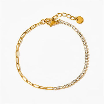 Gold bracelet with chain and diamond-like stone on a white background