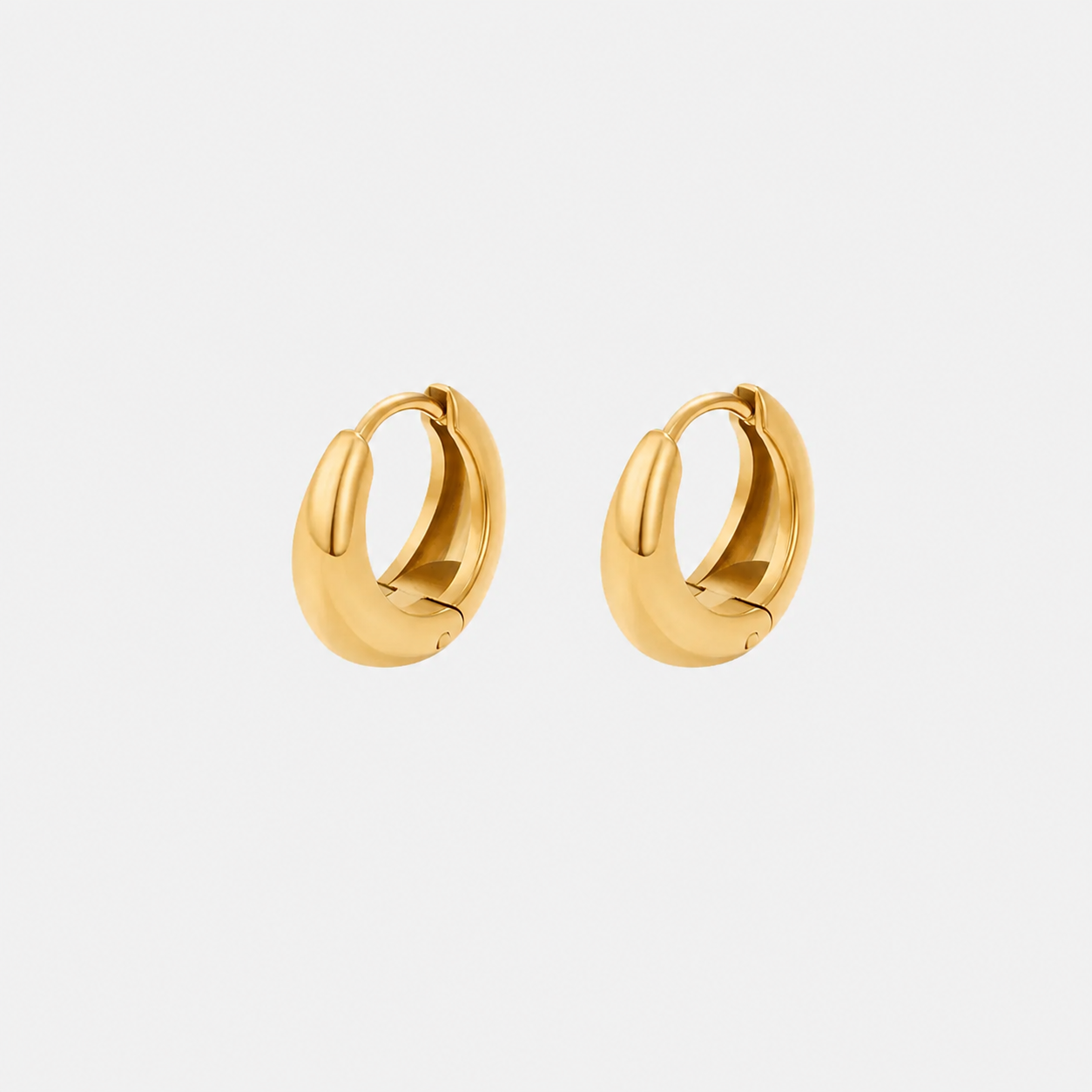 Pair of gold hoop earrings on a white background